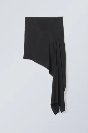 Black draped skirt with asymmetrical pleats.