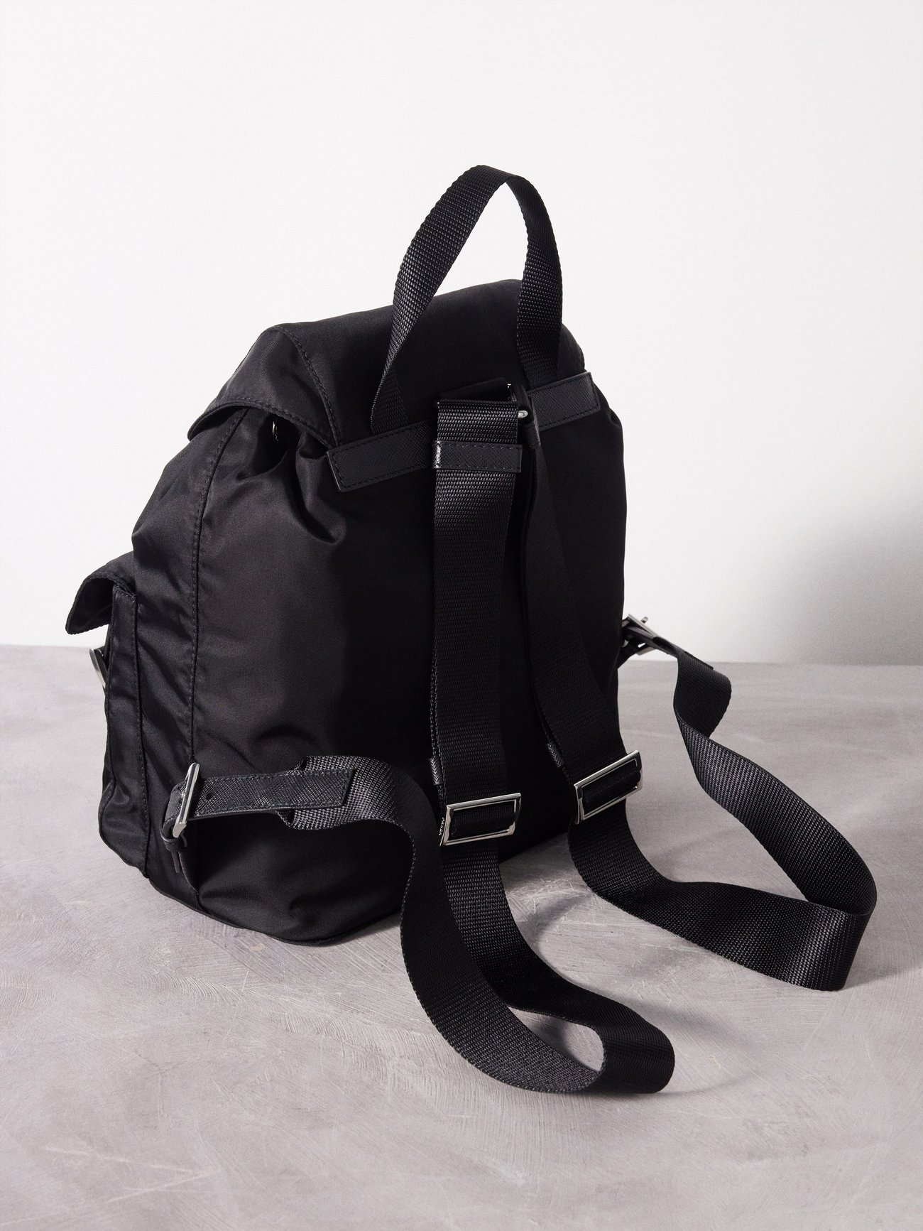 PRADA Triangle Logo-Plaque Small Re-Nylon Backpack | endource
