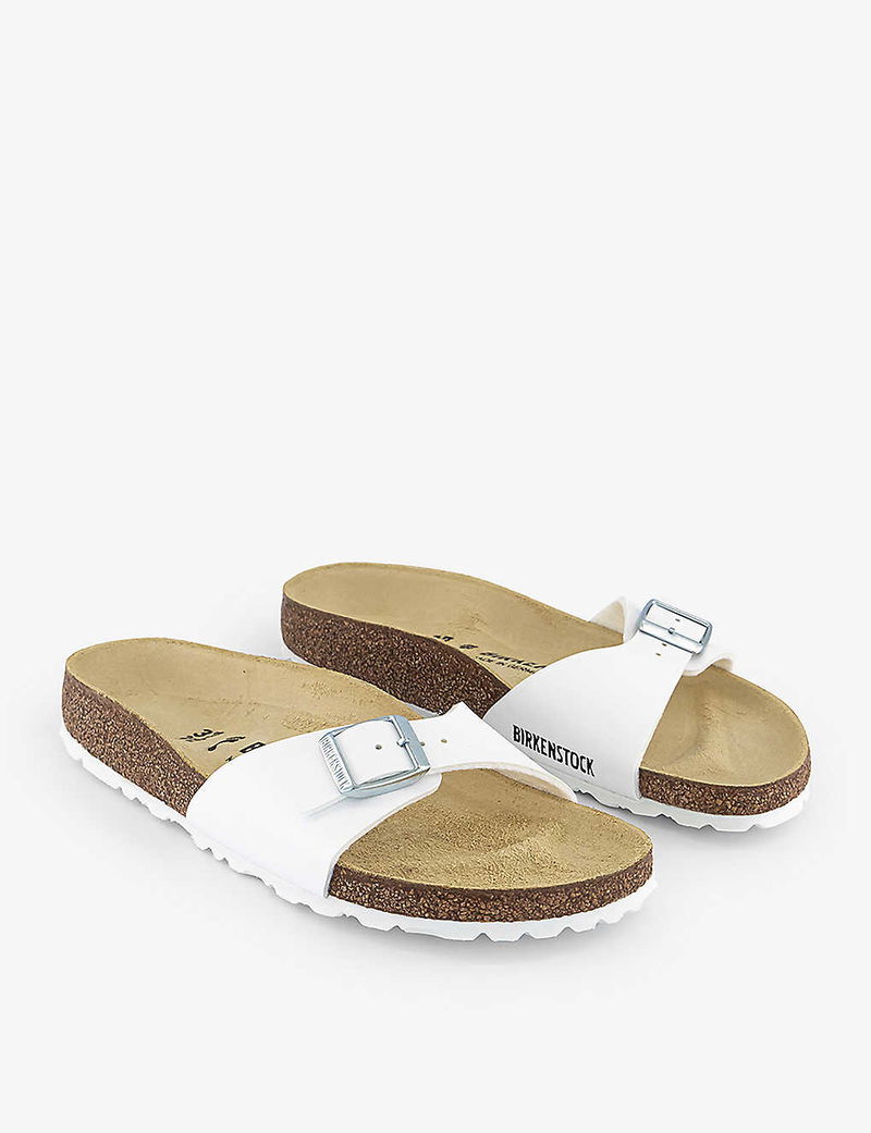 White Birkenstock Arizona slide sandals with silver buckle
