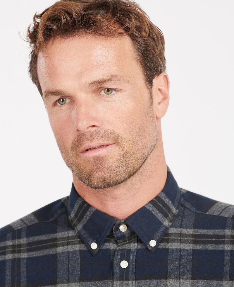 Man wearing a navy Barbour flannel shirt.