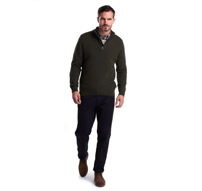 Olive green Barbour quarter-zip sweater with a man wearing a flannel shirt and dark trousers.
