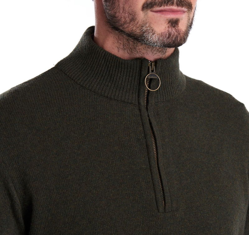 Olive green Barbour zip-neck sweater on a man's upper body.