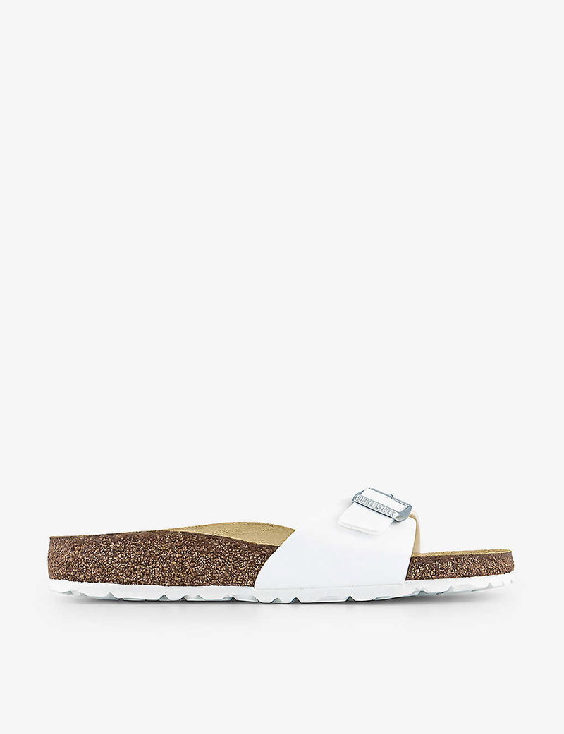 White Birkenstock Arizona sandal with silver buckles and cork footbed.