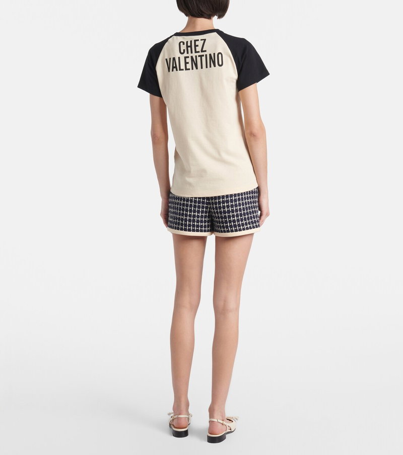 Cream and black t-shirt with Chez Valentino embroidery, paired with plaid shorts.