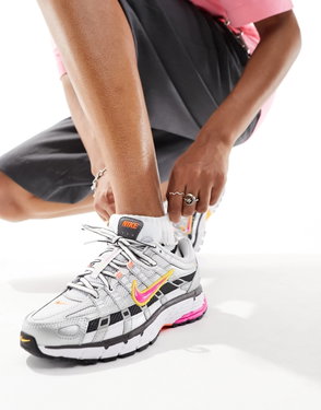 Nike Air Max 90 sneakers on a person's feet, showcasing grid pattern and vibrant accents.