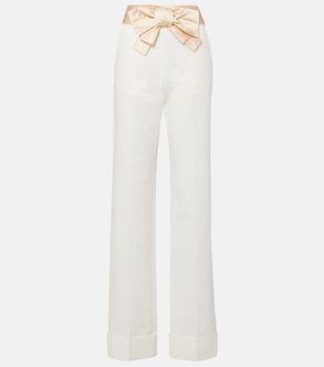 Cream wide-leg trousers with a satin bow belt