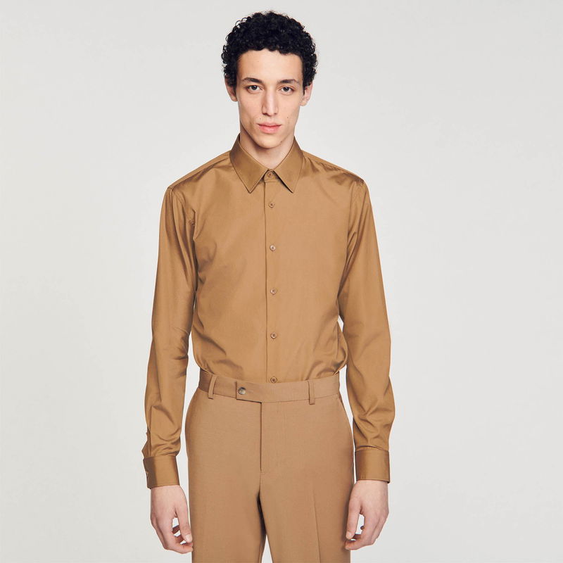 Brown satin shirt and trousers worn by a young man