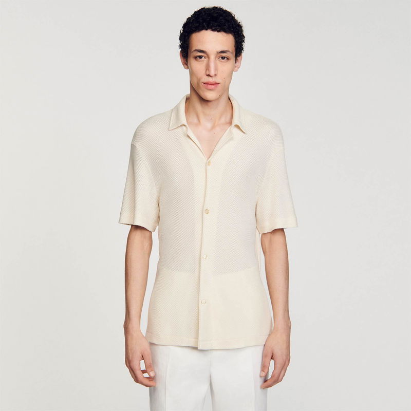 Cream-colored textured short-sleeved shirt on a man.