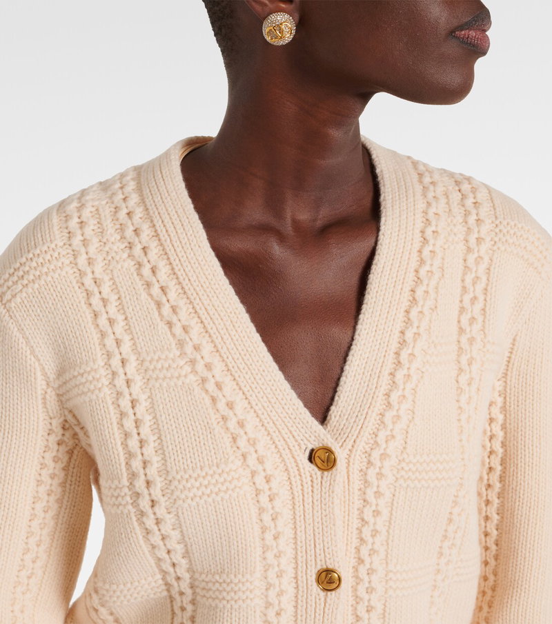 Valentino cream cable-knit cardigan with gold studs.