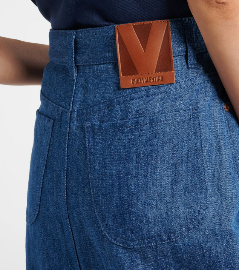 Valentino denim skirt with a brown leather patch.