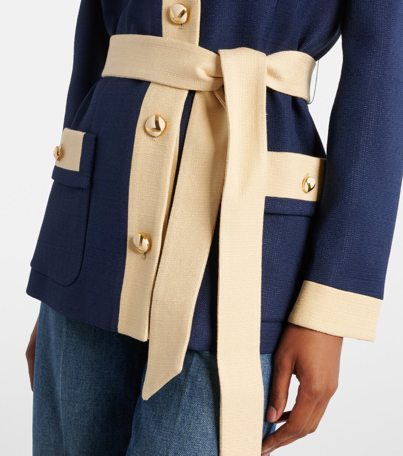 Navy blue jacket with gold buttons and a cream-colored sash.