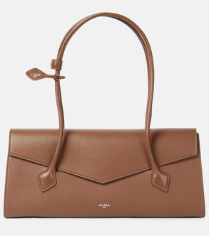 Brown leather shoulder bag with a looped handle.