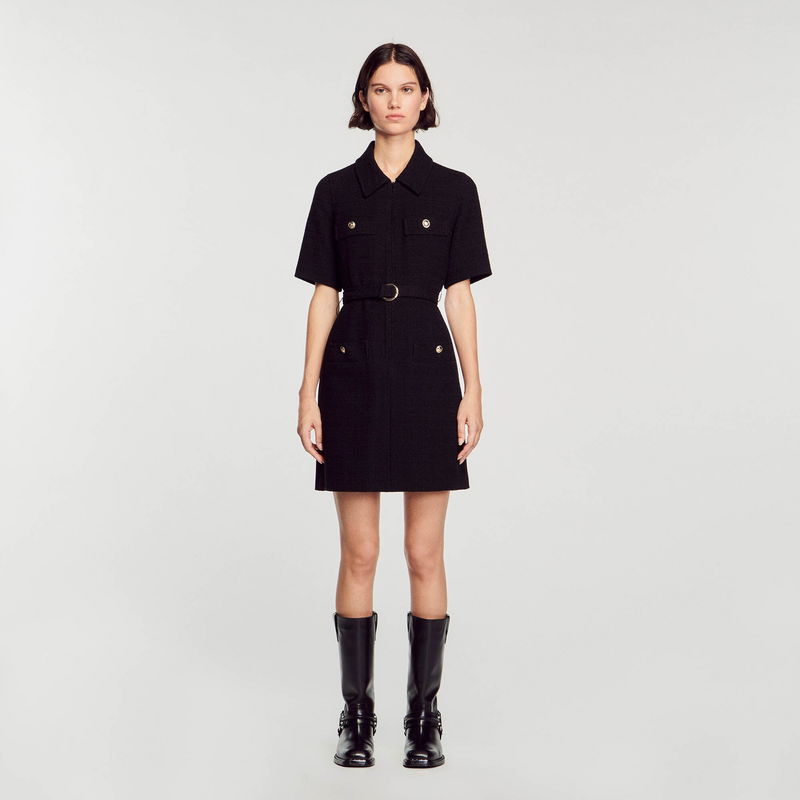 Black belted dress with button details and black boots.
