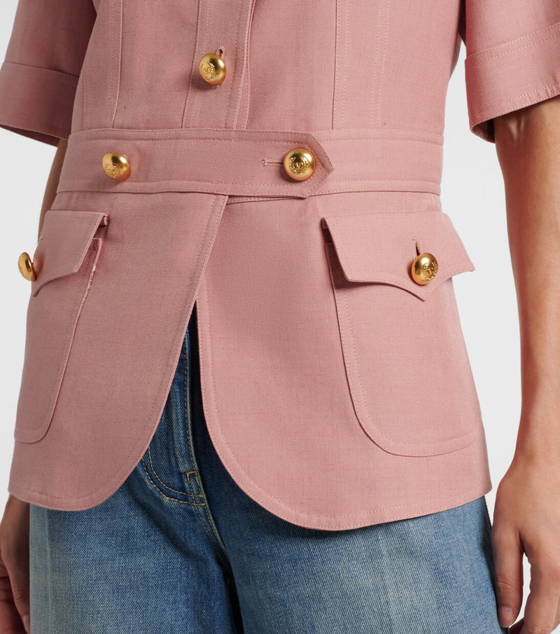 Pink linen blazer with gold buttons and belt detail.