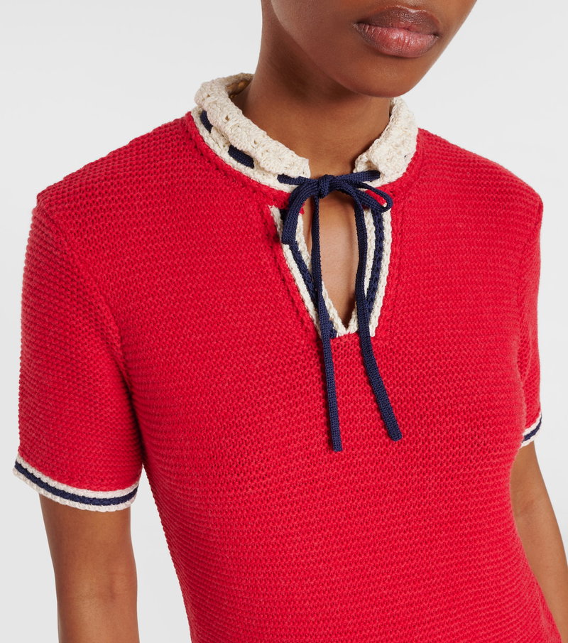 Red knit sweater with white trim and a rope tie detail