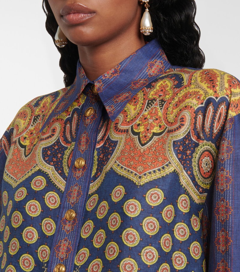 Blue and orange paisley print shirt with gold buttons.