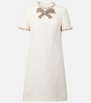 Cream-colored dress with embellished bow neckline