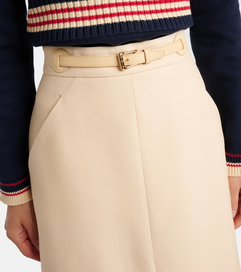 Navy and red striped sweater with a beige leather belt.