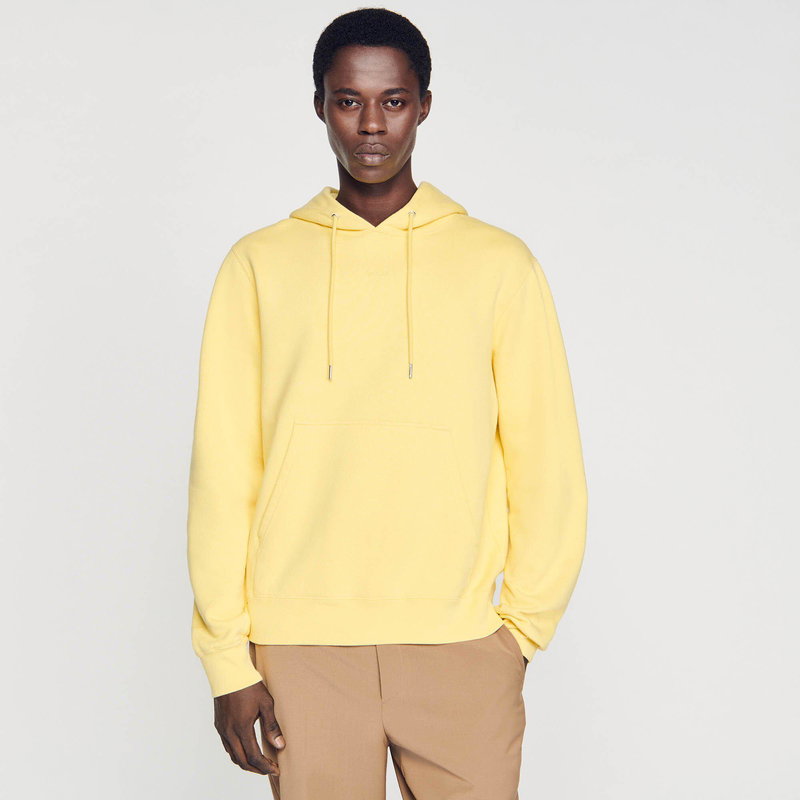 SANDRO - Man in yellow hooded sweatshirt