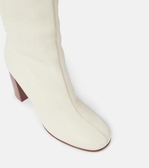 Cream leather knee boots with a chunky wooden heel.