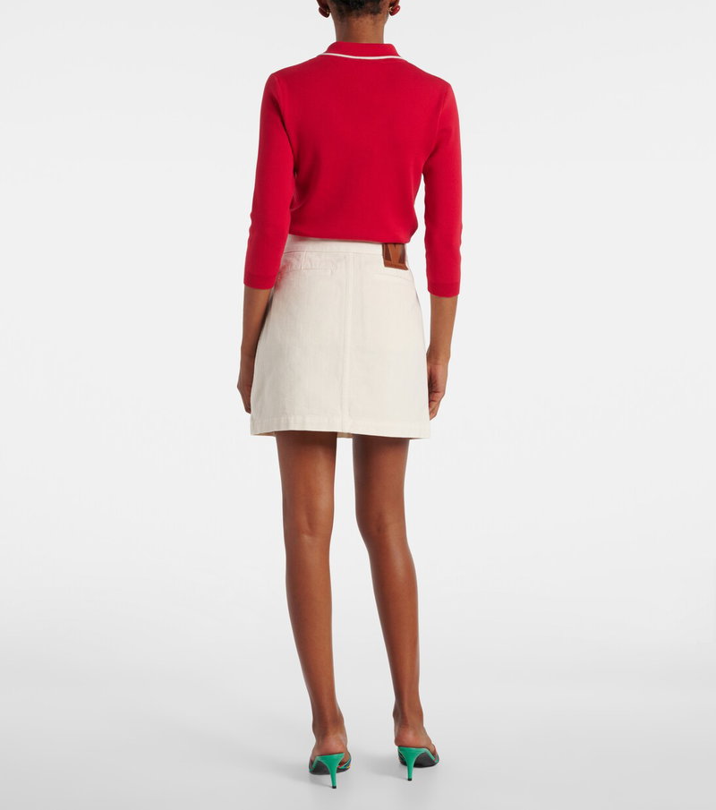 Valentino red sweater and cream denim mini skirt