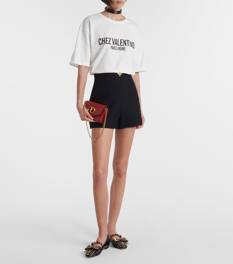Valentino graphic tee, shorts, and shoes with a chain strap bag.
