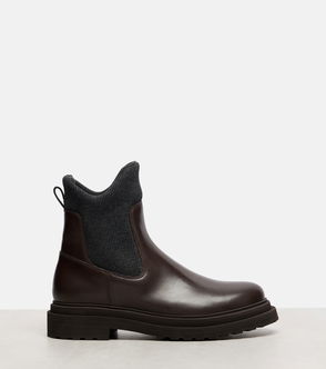 Dark brown leather Chelsea boot with a textured sole.