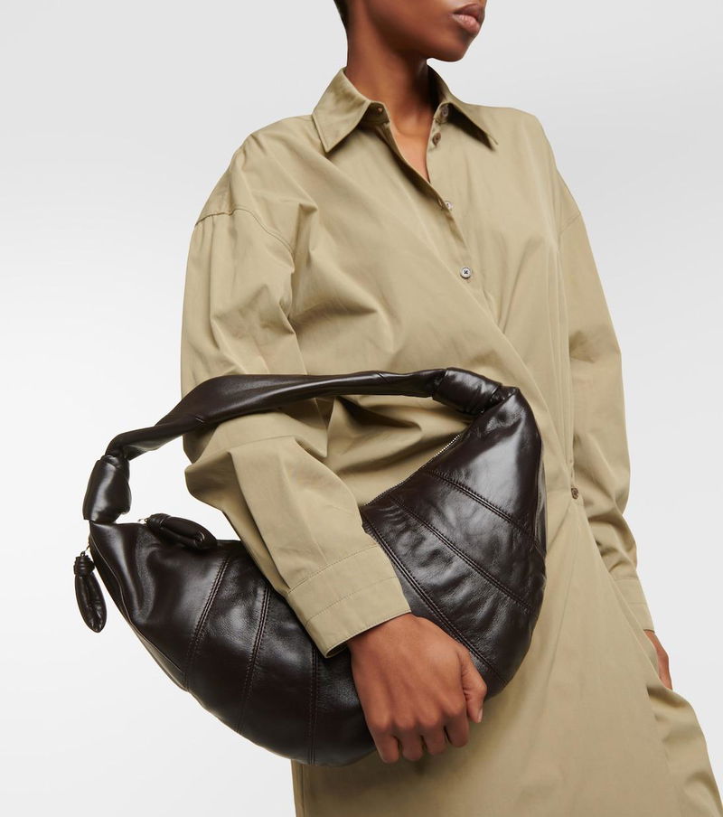 Olive-toned shirt and a dark brown leather slouchy bag.