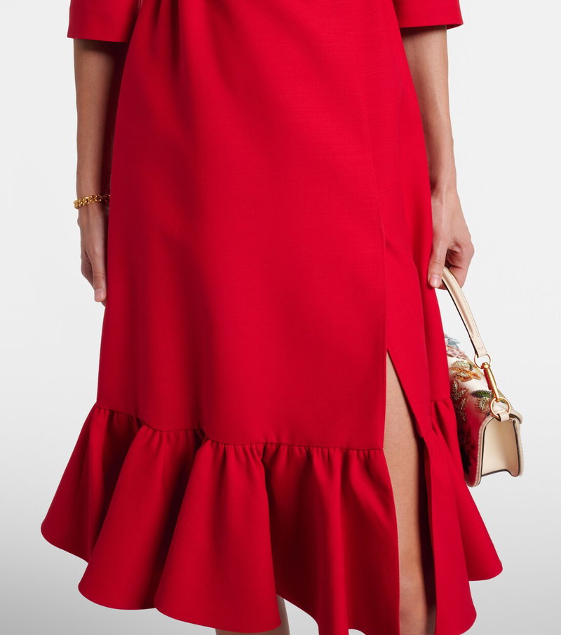 Valentino red midi dress with a ruffled hem and side slit.