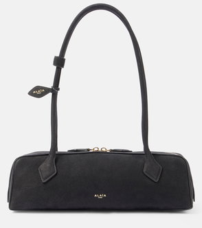 Black Alaïa handbag with a curved handle and leather straps.