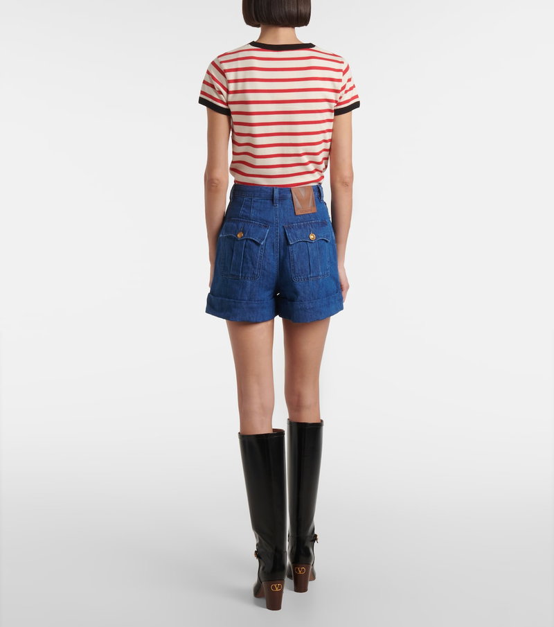 Valentino denim shorts with a model wearing boots.