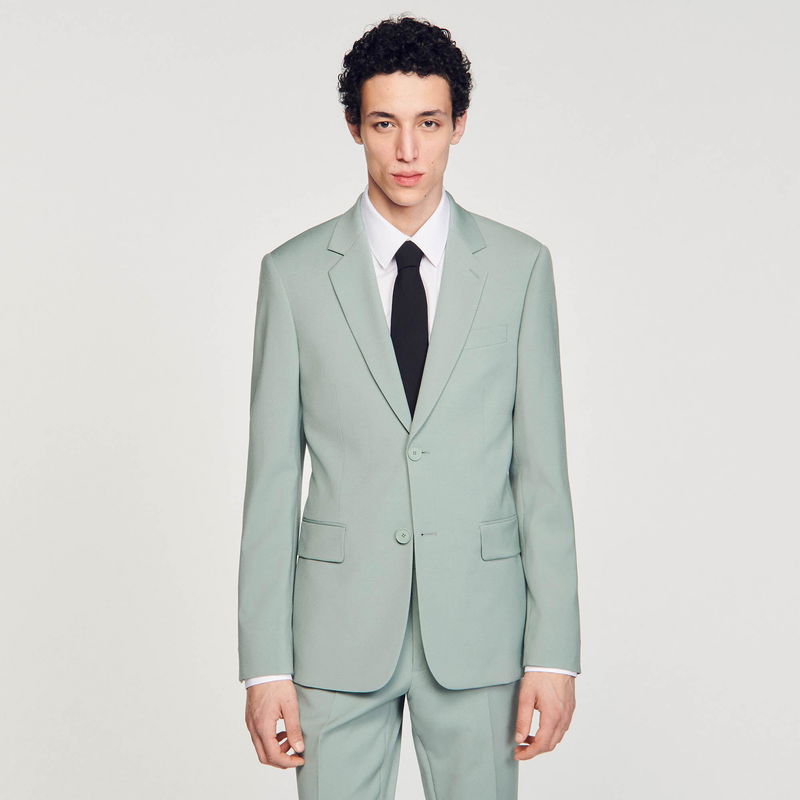 Pale green suit jacket and trousers on a model