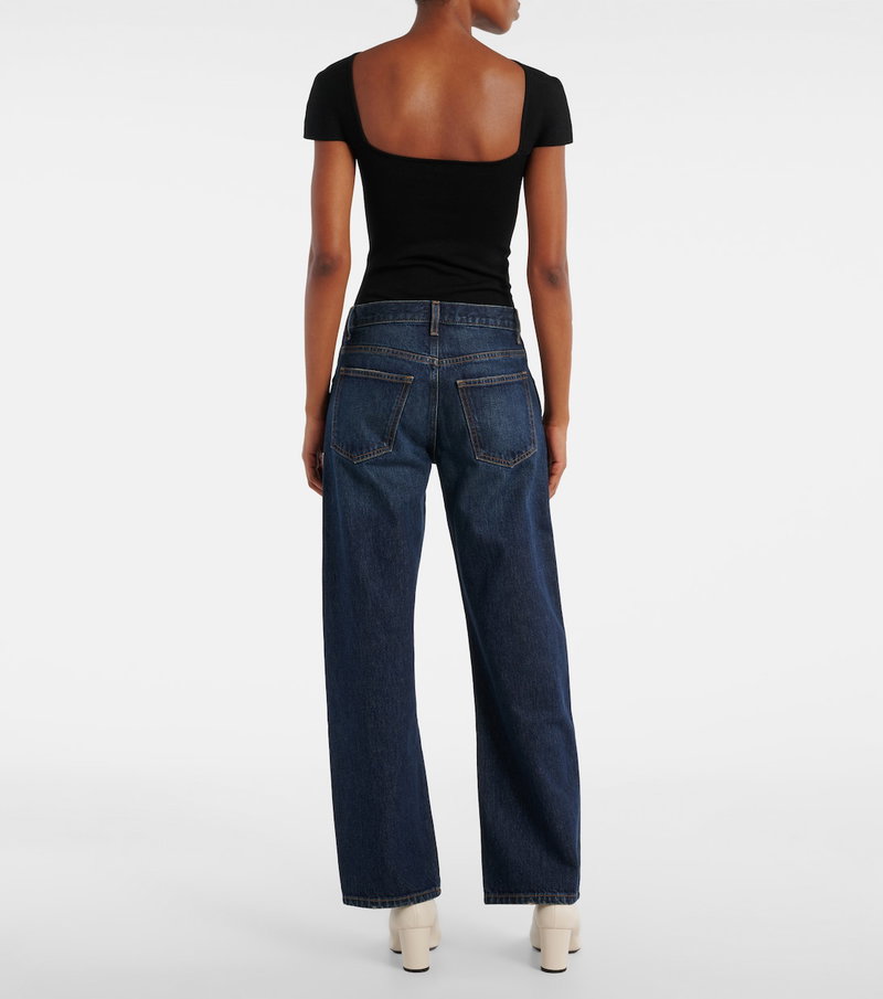 Black ribbed knit top with wide-leg denim jeans