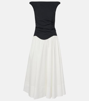 Black satin top paired with a white, voluminous skirt.