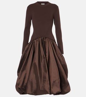 Brown ribbed knit dress with a voluminous taffeta skirt.