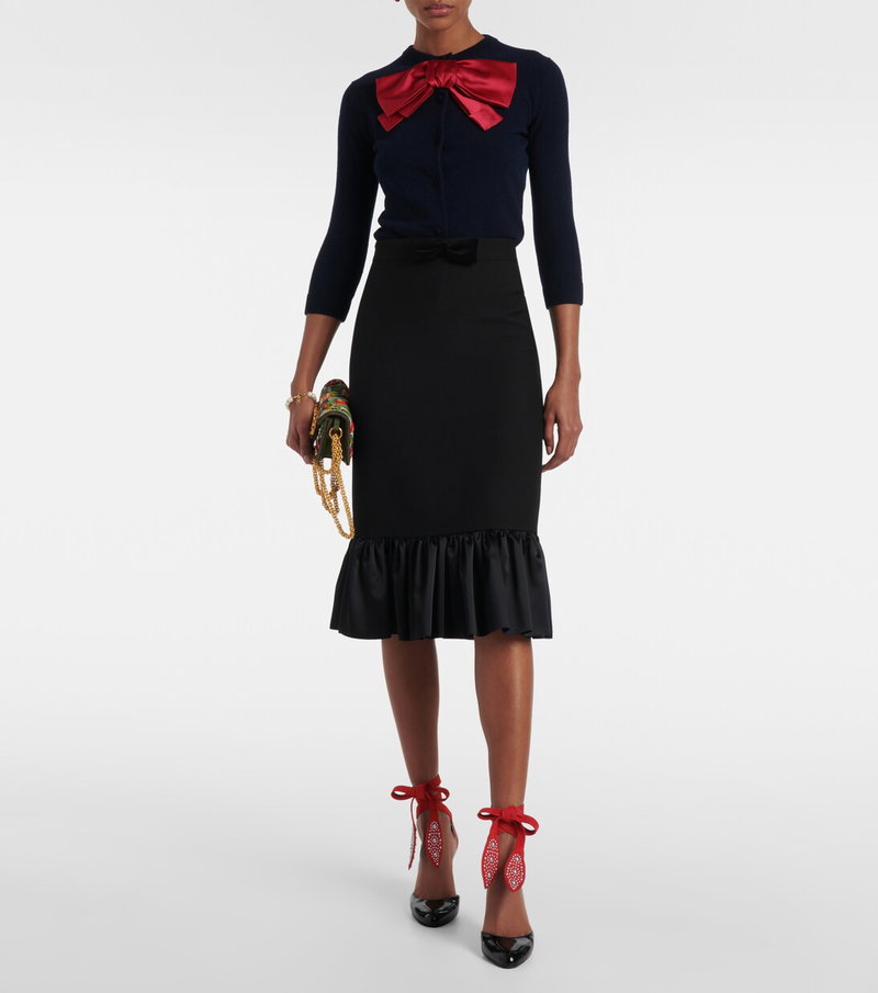 Dark blue sweater with red bow and black ruffled skirt