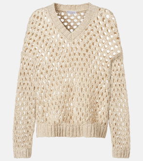 Open-weave, cream-colored cable-knit sweater with a V-neck.