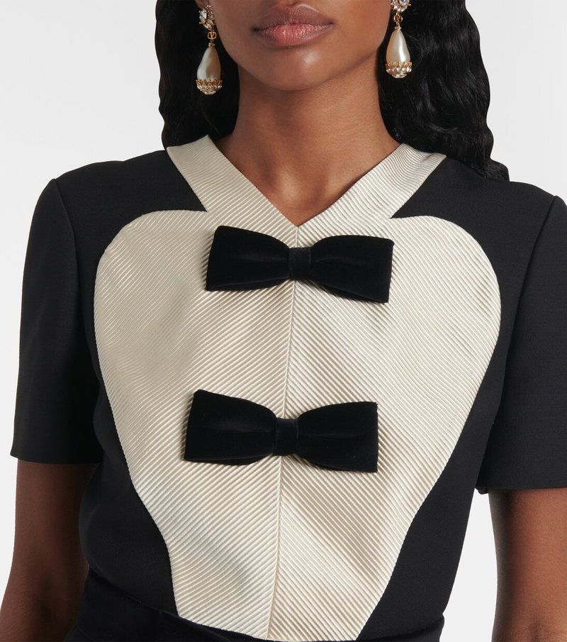 Valentino tuxedo shirt with velvet bow tie and pearl earrings.