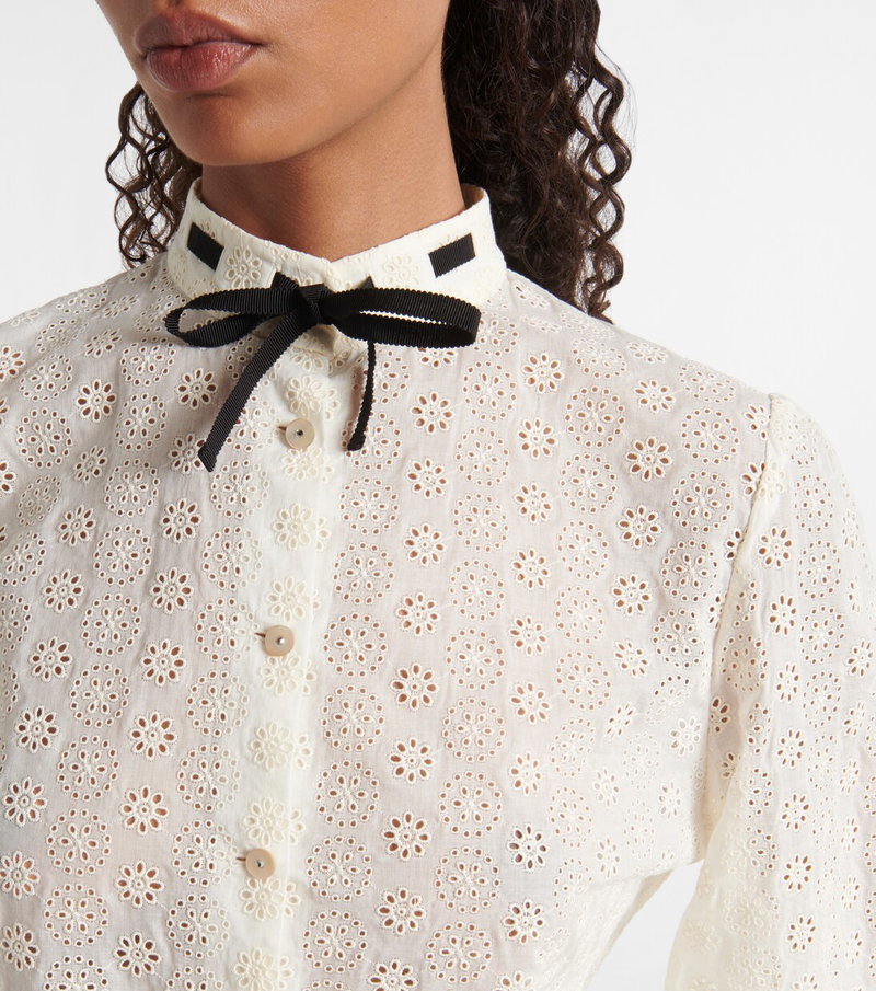 White Valentino blouse with floral lace detailing and black bow.