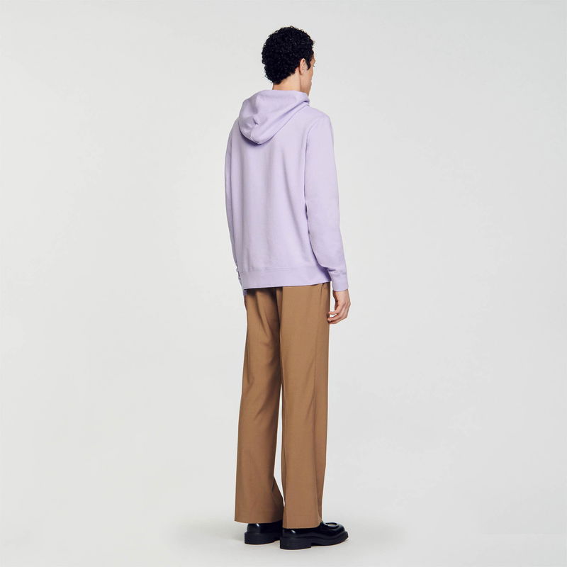 Purple hooded sweatshirt with brown trousers and shoes.