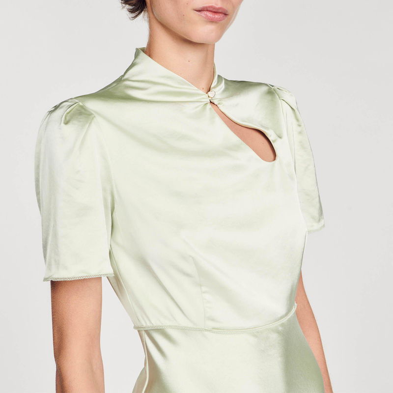 Pale green satin blouse with a keyhole neckline and puffed sleeves.