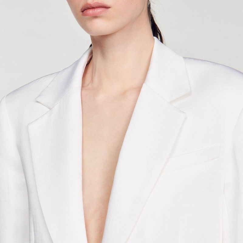 White blazer with a plunging neckline, close-up.
