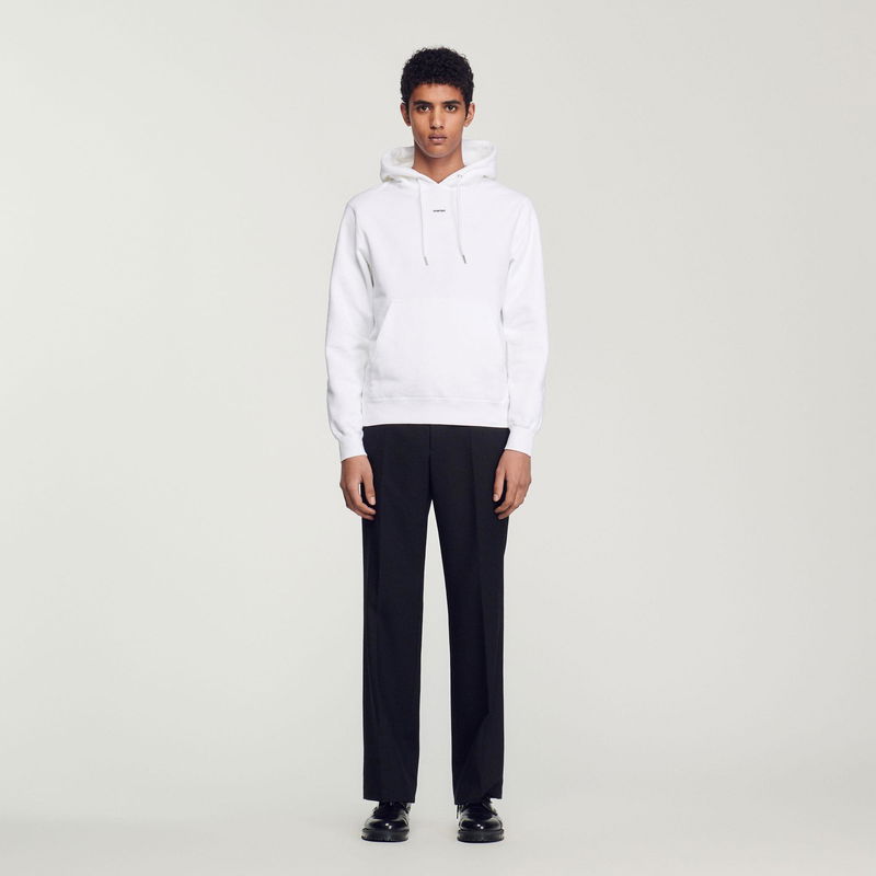 White SANDRO hooded sweatshirt with a Black trouser outfit.