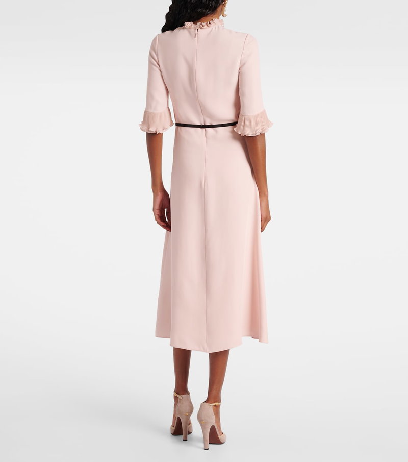 Pink midi dress with ruffled neckline and pleated skirt.