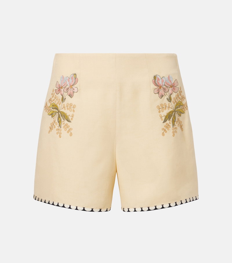 Beige silk shorts with floral embroidery.