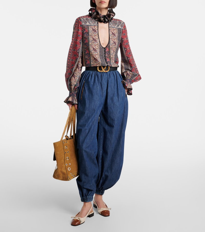 Valentino paisley blouse and wide-leg denim trousers.