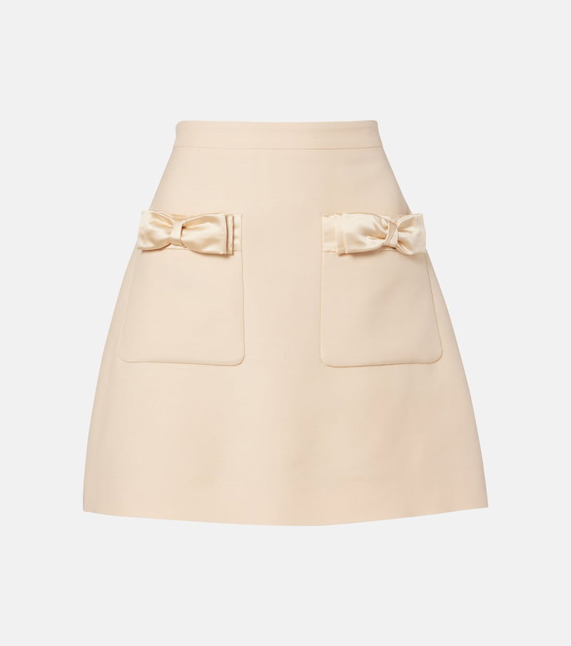 Pale pink satin-trimmed skirt with bow pockets