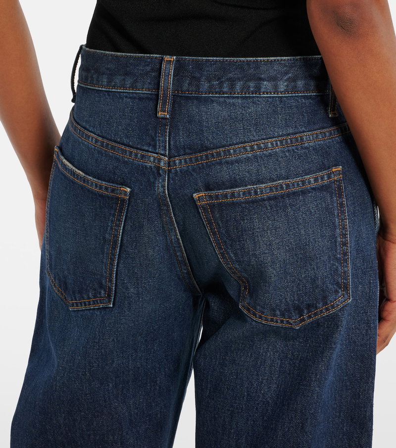 Dark wash denim jeans with gold hardware and back pockets