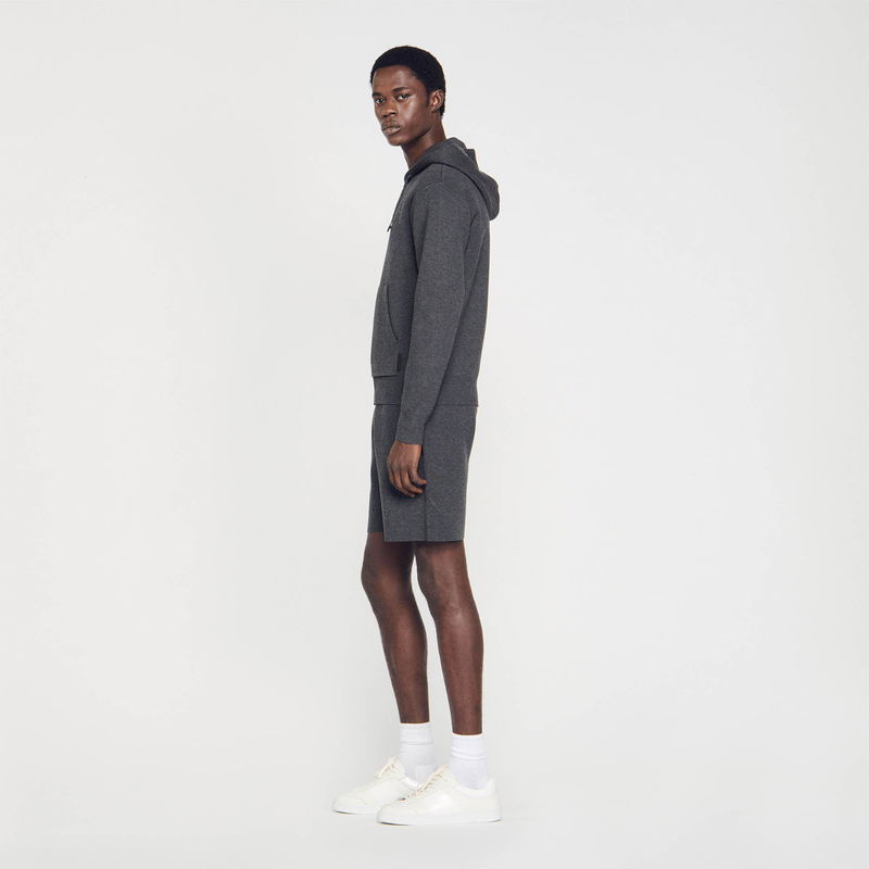 Man in gray SANDRO hoodie and shorts