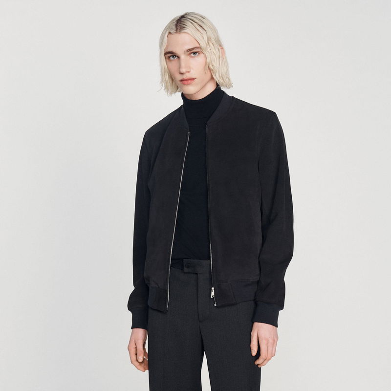 Black suede bomber jacket on a model.
